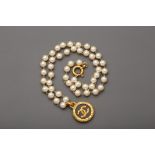 A CHANEL PEARL NECKLACE WITH CC GOLD TONE PENDANT