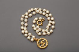 A CHANEL PEARL NECKLACE WITH CC GOLD TONE PENDANT