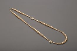 A CHANEL PEARL NECKLACE WITH CLASSIC CC CHARM