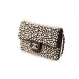 A CHANEL BLACK LEATHER W.O.C WITH PEARL EMBELLISHMENT PURSE