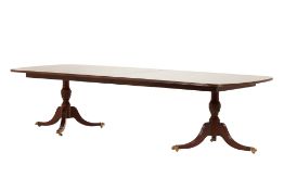 A GEORGE III STYLE TWIN PILLAR EXTENDING DINING TABLE