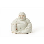 A PORCELAIN FIGURE OF LAUGHING BUDDHA