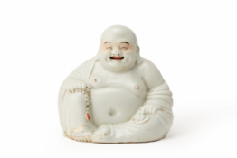 A PORCELAIN FIGURE OF LAUGHING BUDDHA