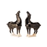 A PAIR OF CHINESE TANG STYLE BLACK GLAZED MODELS OF HORSES