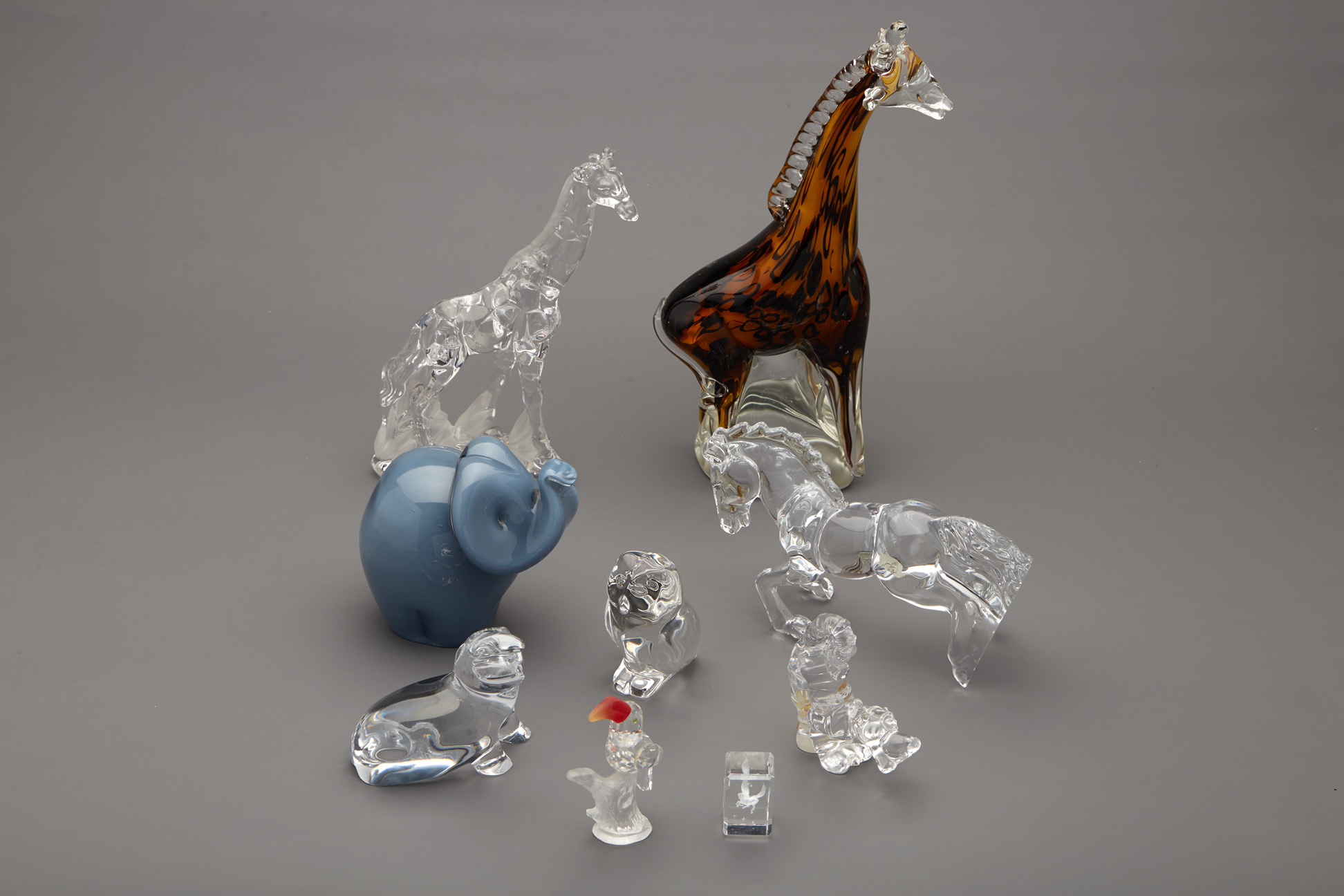 A GROUP OF NINE GLASS & CRYSTAL FIGURINES