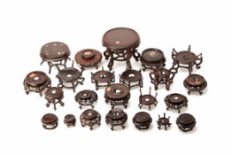 A GROUP OF TWENTY-THREE CARVED WOOD STANDS