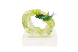 A LIULIGONGFANG CRYSTAL FISH IN A WAVE SCULPTURE