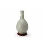 A LARGE MOULDED CELADON PHOENIX BOTTLE VASE