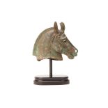 A BRONZE HORSE HEAD ON STAND