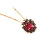 A RUBELLITE AND BLACK DIAMOND CLUSTER PENDANT ON CHAIN