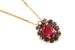 A RUBELLITE AND BLACK DIAMOND CLUSTER PENDANT ON CHAIN