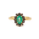 AN EMERALD AND BLACK DIAMOND CLUSTER RING