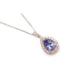 A TANZANITE AND DIAMOND CLUSTER PENDANT ON CHAIN