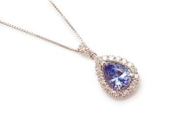 A TANZANITE AND DIAMOND CLUSTER PENDANT ON CHAIN