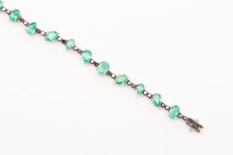 AN 18K WHITE GOLD EMERALD AND BLACK DIAMOND BRACELET