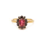 A RUBELLITE AND BLACK DIAMOND CLUSTER RING
