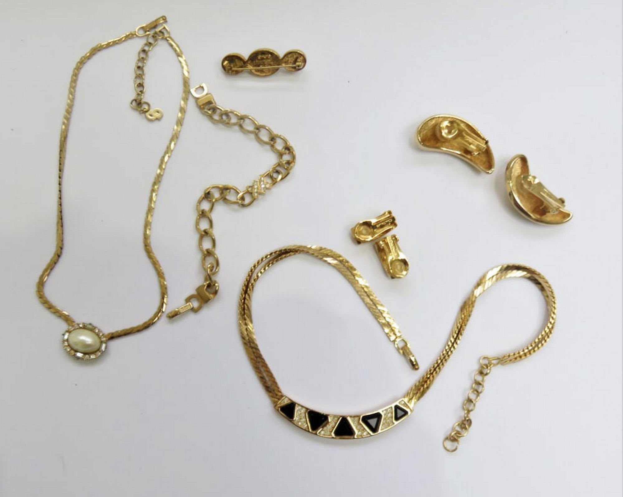 Christian Dior gold tone costume jewellery, two necklaces, one bracelet, one brooch, two pairs Ear.