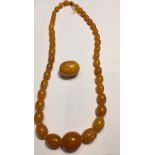 Vintage Honey Coloured Amber/Bakelite Necklace 57cm long with extra large Bead 10 grams.