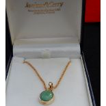 Boxed 9ct gold pendant and chain. Stone believed to be Jade.