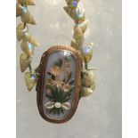 Antique Cased Shell Necklace 12" long with Yellow Metal Floral Pendant 1 1/4" x 5/8" plus Pendant.