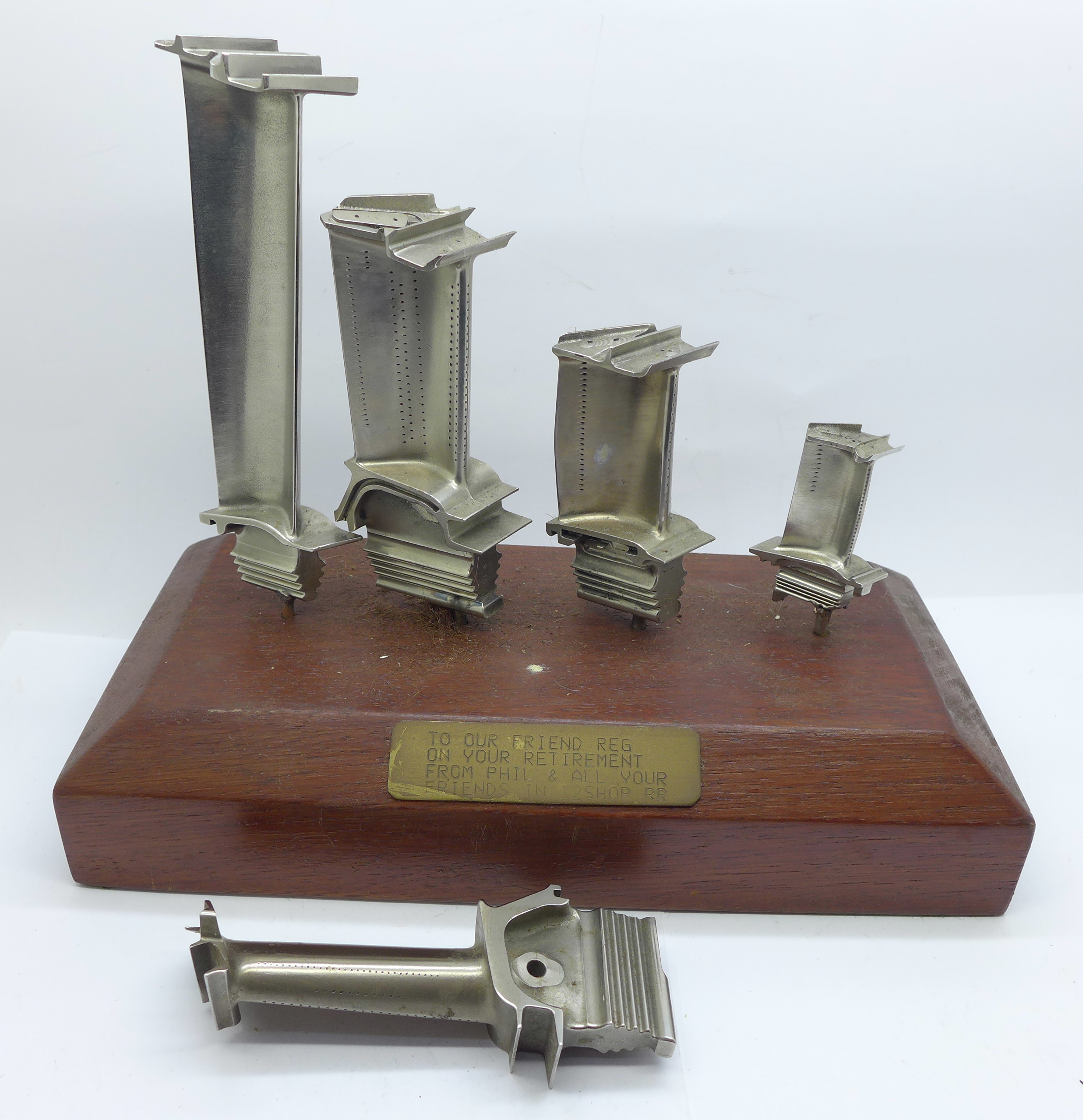 Four mounted jet engine turbine blades and one loose, with Rolls-Royce related presentation plaque