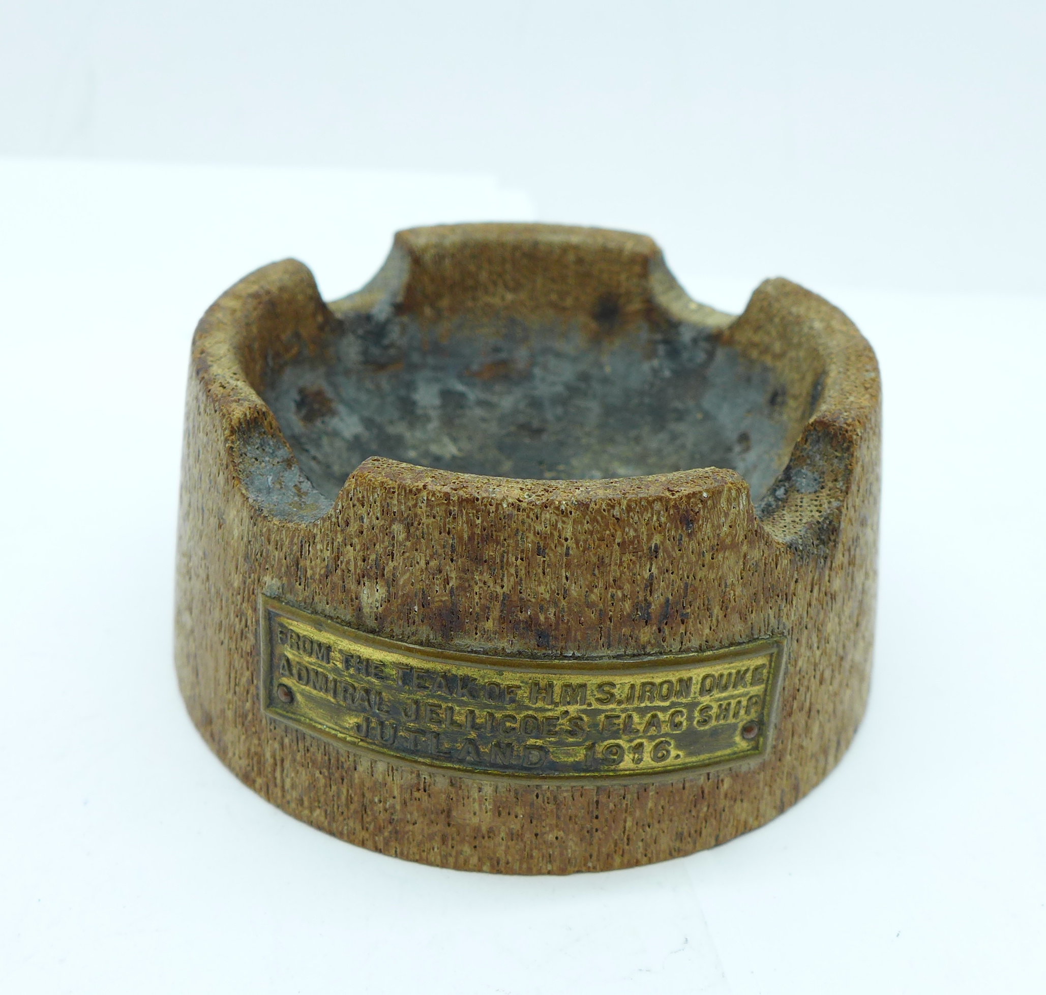 A wooden ashtray with small plaque, 'Teak of H.M.S. Iron Duke, Admiral Jellicoe's Flagship,