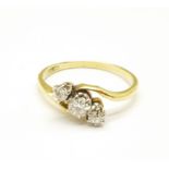 An 18ct gold, three stone diamond trilogy ring, 2.8g, R