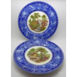 A pair of Clarice Cliff plates with blue and white borders and coloured scenes in the centre