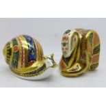 Two Royal Crown Derby paperweights with gold stoppers, snail and snake