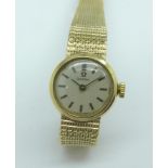 A lady's 9ct gold Omega wristwatch with a 9ct gold integrated bracelet strap, total weight 21.2g