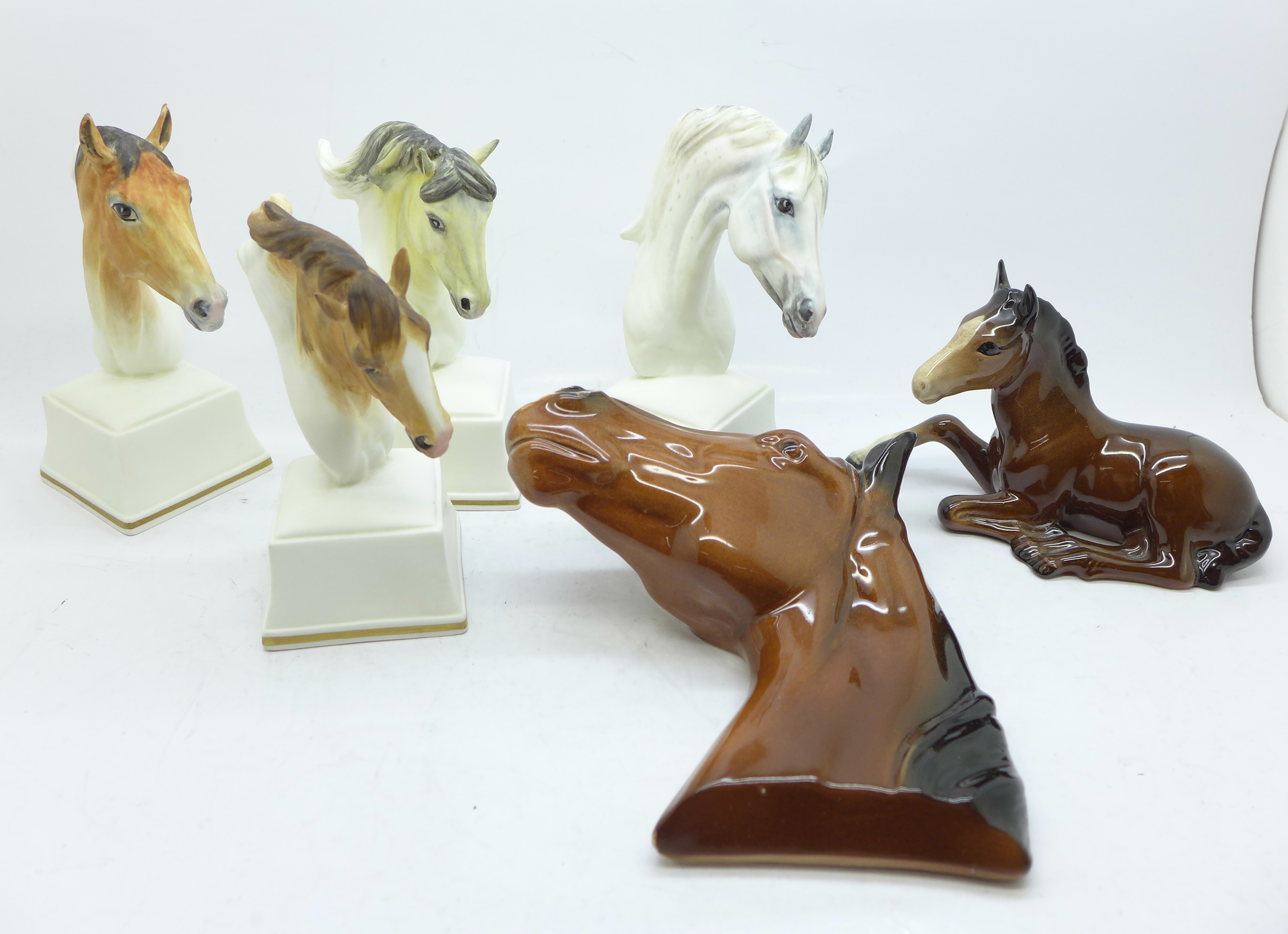 Four Royal Worcester horse busts, a Beswick foal and one other horse plaque