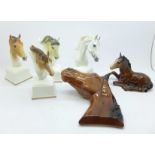 Four Royal Worcester horse busts, a Beswick foal and one other horse plaque