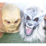 An alien head mask and a werewolf head mask