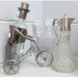 Three glass decanters, a claret jug and a novelty bottle holder
