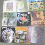 A collection of eleven LP records, including Bob Dylan and John Lennon