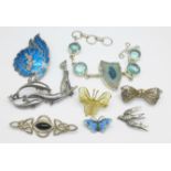 Eight silver brooches and a bracelet