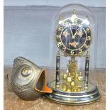 A Kundo anniversary clock and a stylised model fish