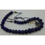 A heavy blue carved stone necklace