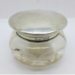A silver topped glass jar, jar chipped