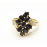 A 9ct gold, sapphire cluster ring with diamond shoulders, 3.2g, P