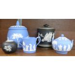 Three items of Wedgwood Jasperware, a match striker and a lidded pot