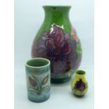 Three pieces of Moorcroft, a vase, 19cm, miniature vase and cylindrical vase, chip to the foot of