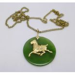A yellow metal and jade horse pendant on a yellow metal chain