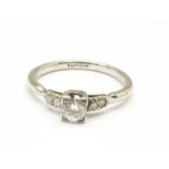 A platinum and diamond solitaire ring with diamond shoulders, 3.5g, P