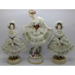 Two similar Sitzendorf lace work figures and one other taller figure, 27cm