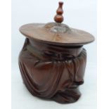 A carved Chinese lidded pot in the form of a sleeping seated elder