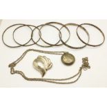 A silver locket and chain, a silver brooch and six sterling silver bangles, 84.6g