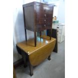 An oak drop leaf table and a mahogany music cabinet