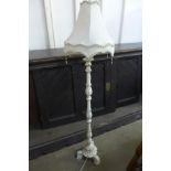 A cream painted standard lamp