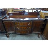 An Edward VII Chippendale Revival carved mahogany serpentine sideboard